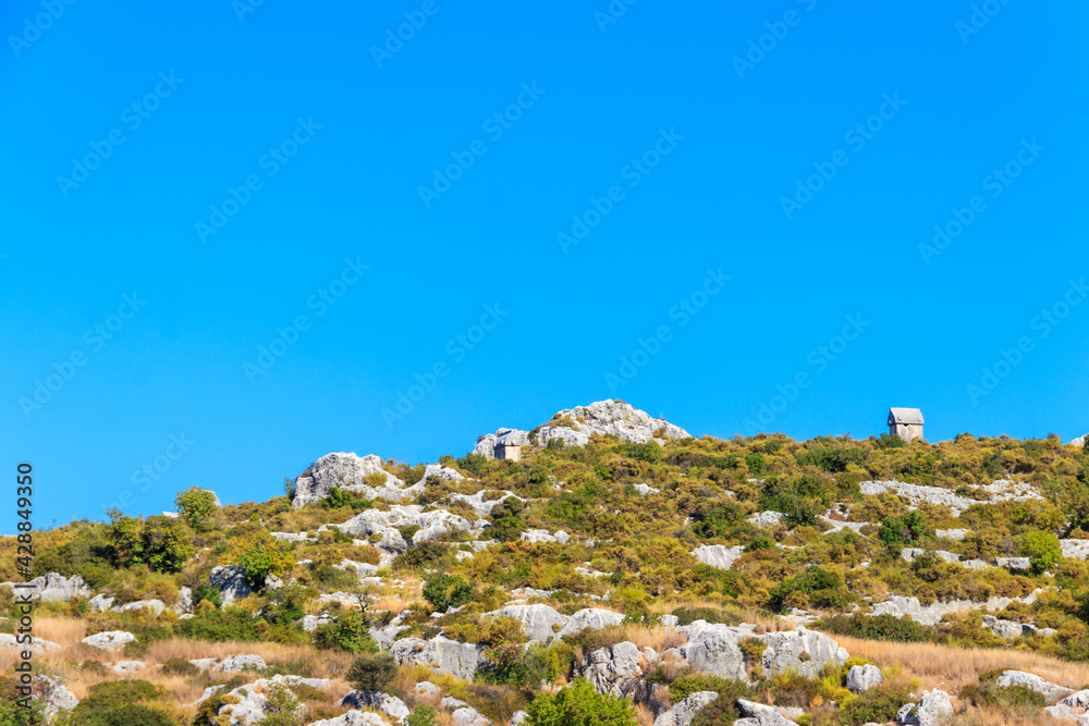 Lycian tombs below turkish Simena fortress near Kekova island in Antalya province, Turkey