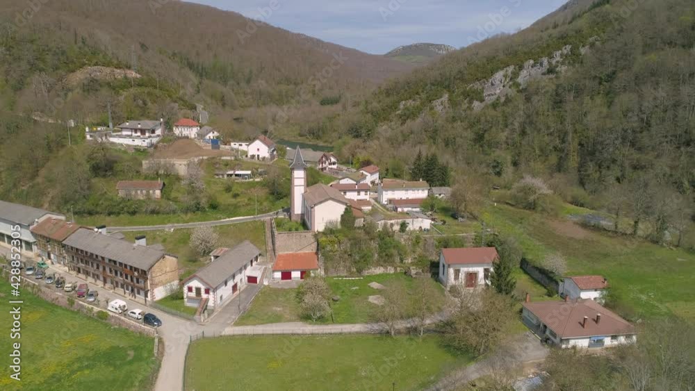 Majestic small town with church tower in forestry valley, aerial view Majestic small town with church tower in forestry valley, aerial view