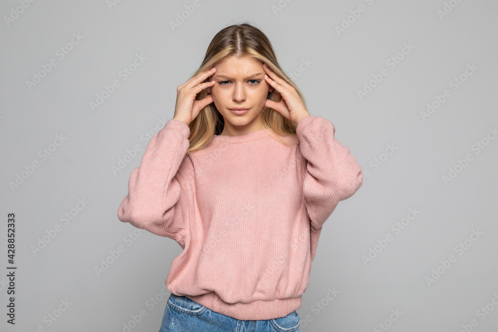 Young woman with headache isolated on gray background Young woman with headache isolated on gray background