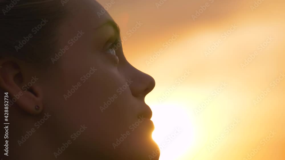 Portrait of a happy young teenager girl on the street. The girl dreams with pleasure with her eyes closed. The lady feels free, successful, ready to start the day, move forward. Portrait of a happy young teenager girl on the street. The girl dreams with pleasure with her eyes closed. The lady feels free, successful, ready to start the day, move forward.