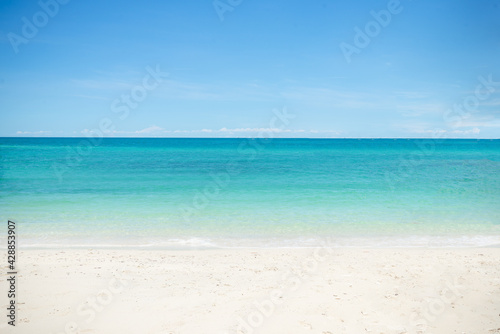Beautiful wide of seascape with blue sky at daylight. Sand of beach smooth Sea. © setthawuth