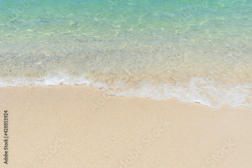 Beautiful clear sand beach and tropical light blue sea. Soft wave of blue ocean on sandy beach. Sallow water, Clear water. Seaside. © setthawuth