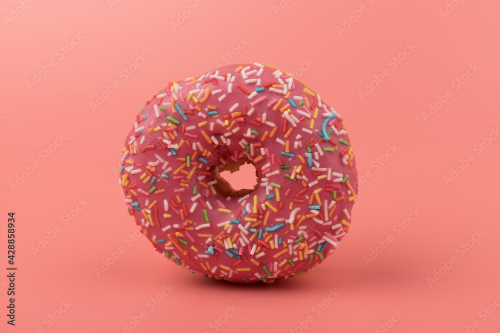 Fresh made Donuts isolated on pink background. Doughnuts are traditional sweet pastries. Copy space for text. Fresh made Donuts isolated on pink background. Doughnuts are traditional sweet pastries. Copy space for text.
