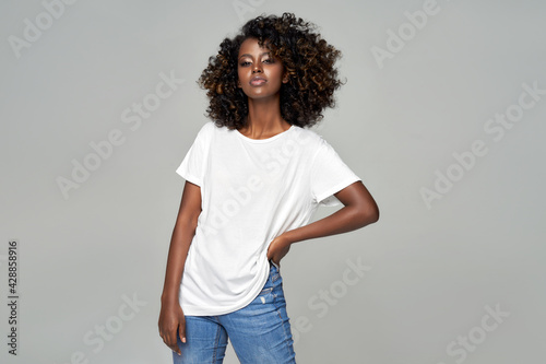 Black woman with afro hair wear classic outfit isolated on gray background