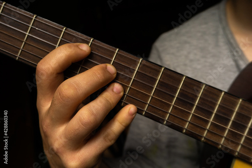 Macro shot of Man playing Spanish guitar