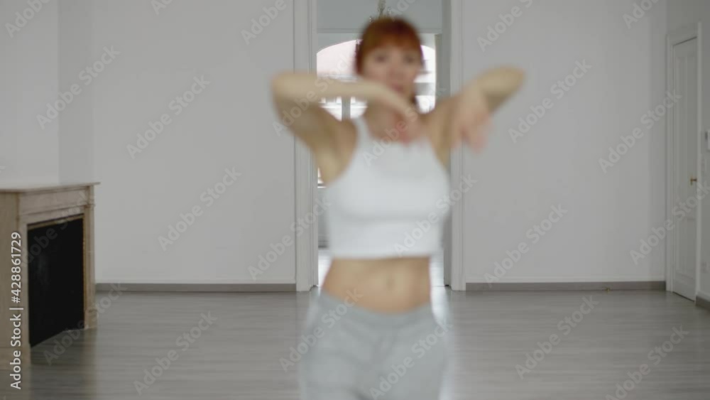 dancer in casual sports clothes, she dances softly alone in school rehearsing the choreography. Elegance of movements and dance concept dancer in casual sports clothes, she dances softly alone in school rehearsing the choreography. Elegance of movements and dance concept