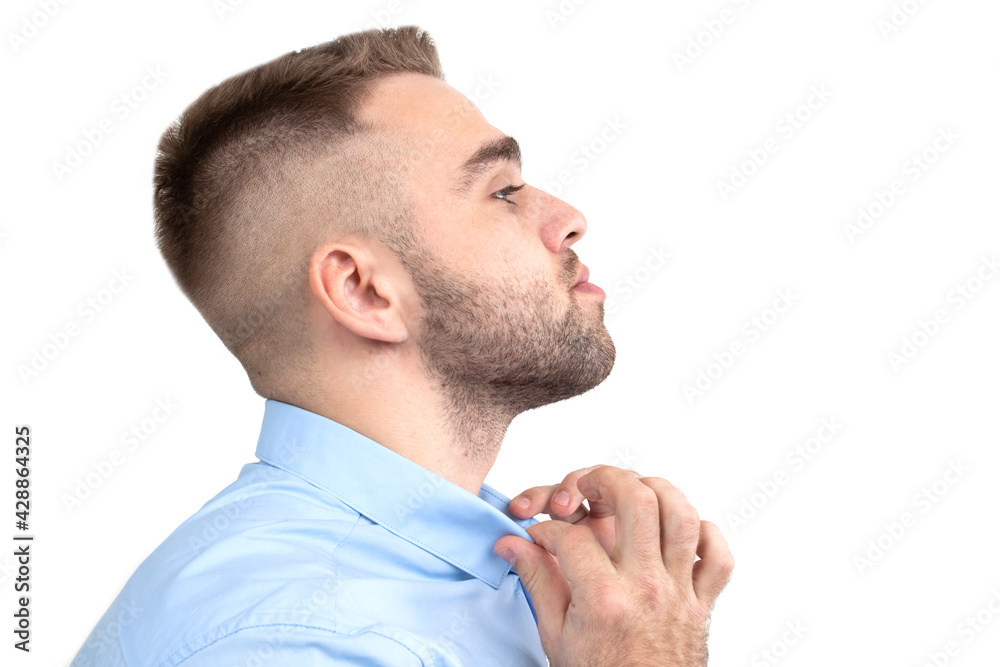 Fototapeta premium Portrait of a young man in a blue shirt on a white background