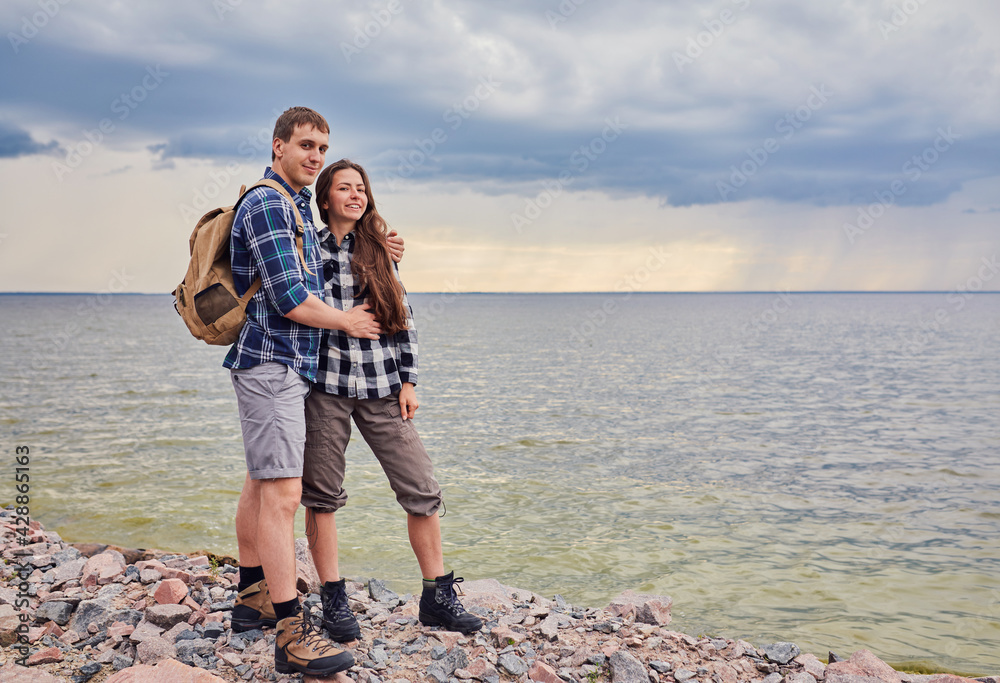 Couple with travel backpacks enjoying their summer vacation trip