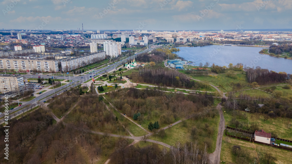 Aerial photography of the spring city park. Park alleys and a reservoir on the outskirts of the city.