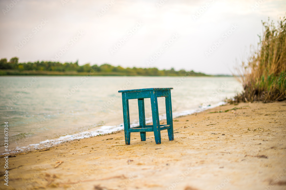 The stool stands on the bank of the river The stool stands on the bank of the river