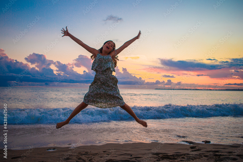 Little happy funny girl have a lot of fun at tropical beach playing together