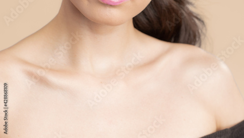 Women neck and shoulders on nude background