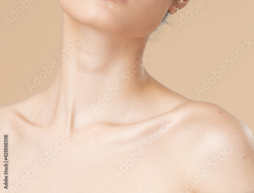 Women neck and shoulders on nude background