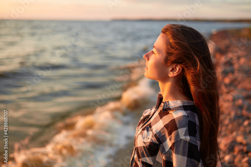 Portrait of young beautiful woman in sunset