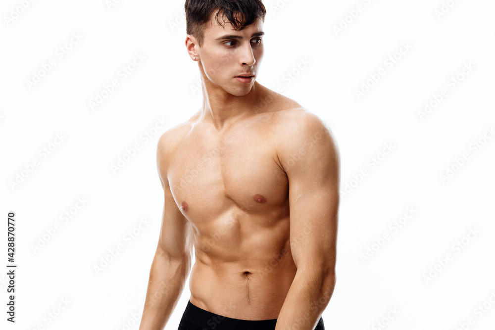 attractive man with an athletic physique and cubes on his stomach attractive man with an athletic physique and cubes on his stomach