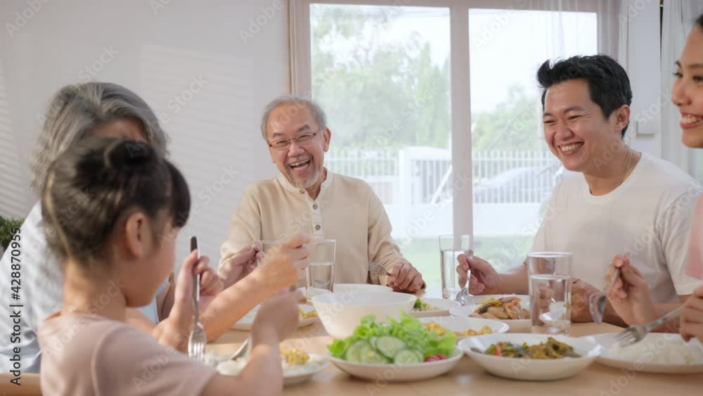 Asian big family having lunch on dining table together at home. Asian big family having lunch on dining table together at home.