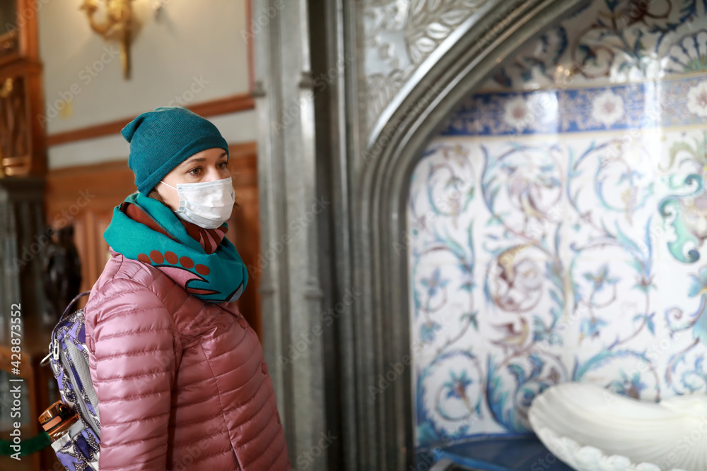 Woman inspects oriental fountain