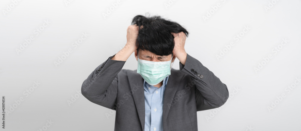 Depress and Serious Businessman wearing an anti virus protection mask to prevent others from corona COVID-19 and SARS cov 2 infection. Protection versus viruses and infection Depress and Serious Businessman wearing an anti virus protection mask to prevent others from corona COVID-19 and SARS cov 2 infection. Protection versus viruses and infection