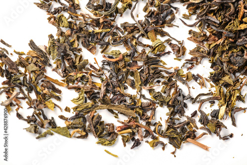 pile of loose green tea - dry green tea leaf isolated on white background