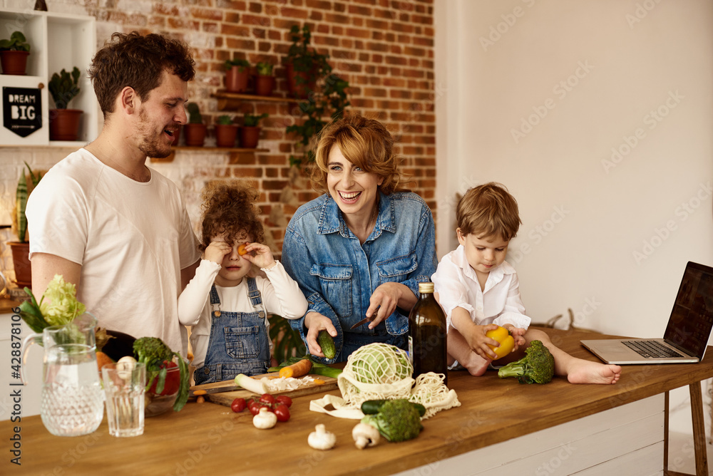 happy family with their children cooking in the kitchen