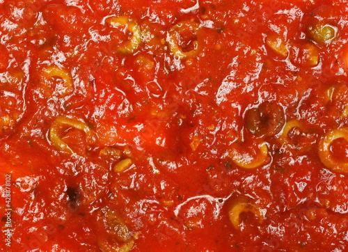 Pasta tomato sauce with olive slice background and texture  top view