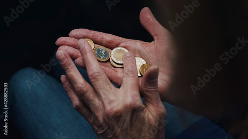 Quadro su tela Wrinkled hands of elderly woman counting coins