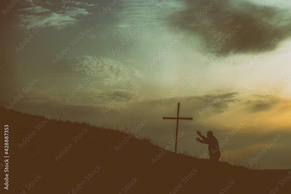 Old man kneel before Jesus cross