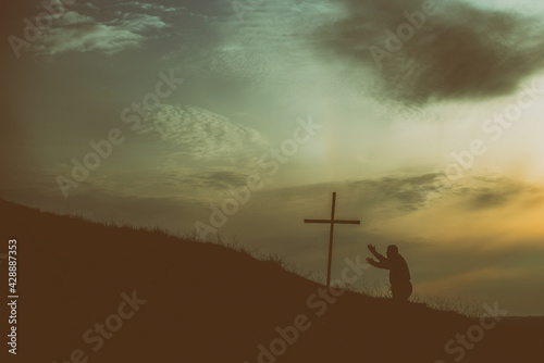 Old man kneel before Jesus cross