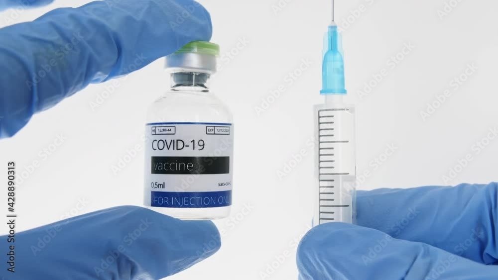 COVID-19 Vaccine in Researcher Hands, Doctor's Hand Holds a Syringe and a Vaccine Ampoule at the Hospital. New Medication Developing, Vaccination. Prevention of flu. High quality 4k footage COVID-19 Vaccine in Researcher Hands, Doctor's Hand Holds a Syringe and a Vaccine Ampoule at the Hospital. New Medication Developing, Vaccination. Prevention of flu. High quality 4k footage