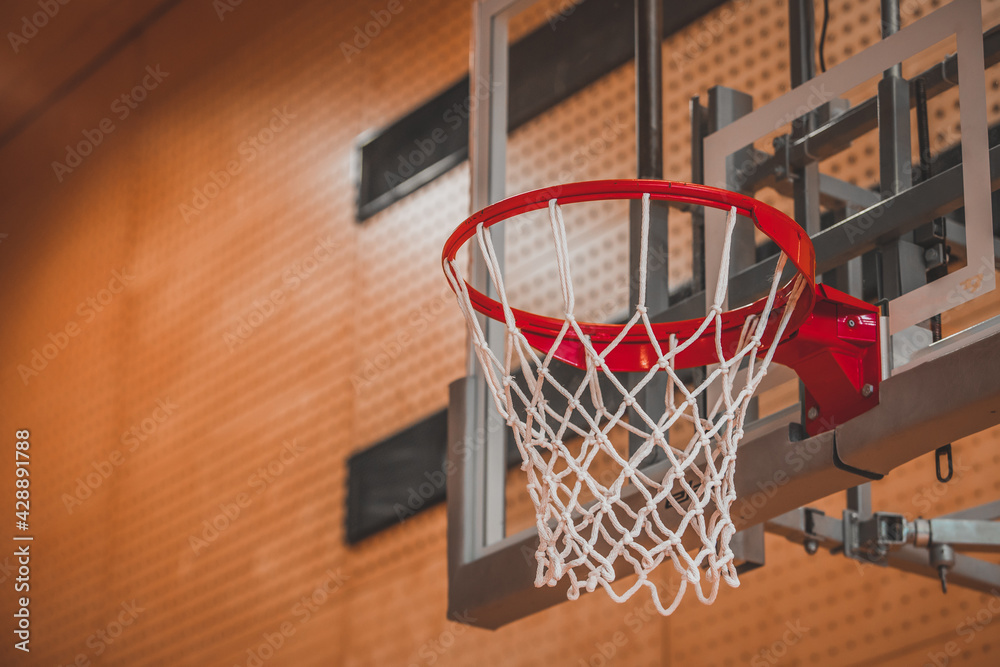 view of a net on a baksketball table viewed from under the basket in a gym or stadium.