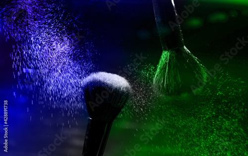 Canvas Print explosion of green and blue eyeshadows on dark background