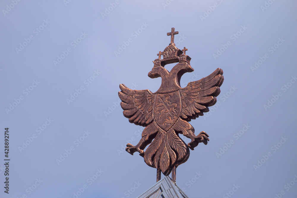 Historical coat of arms of the Russian Empire on wooden roof Historical coat of arms of the Russian Empire on wooden roof