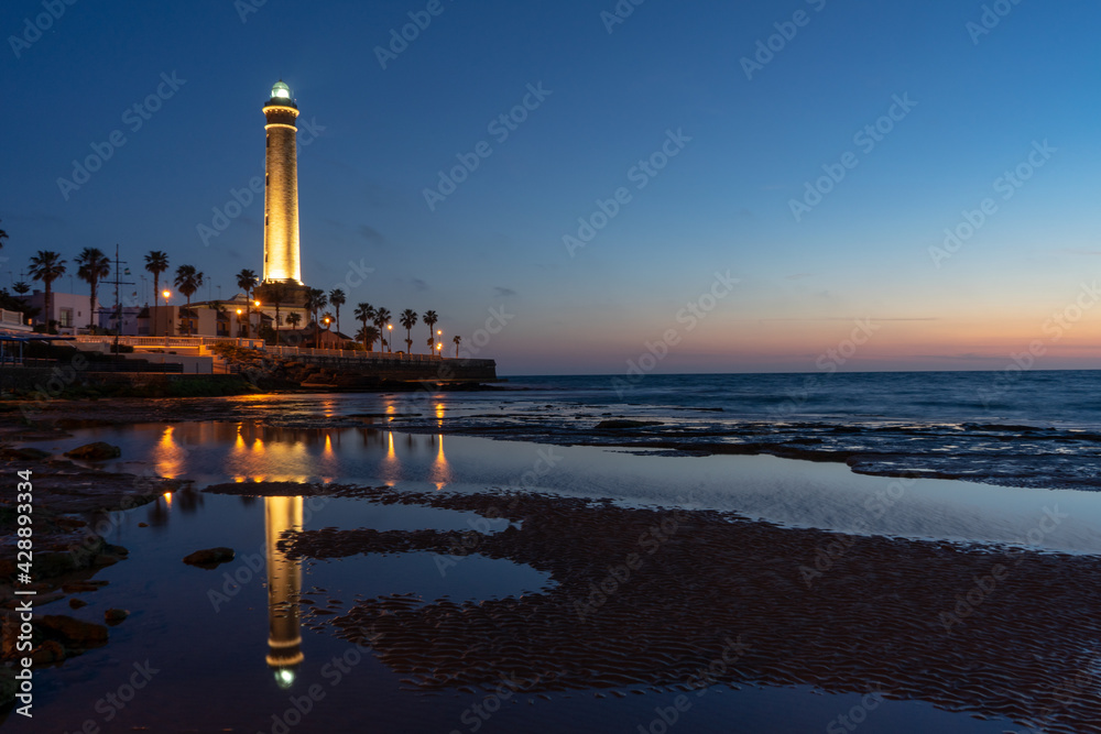 Naklejka premium horizontal view of the Chipiona lighthouse in Andalusia at sunset