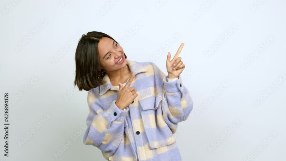 Young latin woman pointing a great idea and looking up over isolated background Young latin woman pointing a great idea and looking up over isolated background
