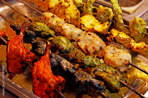 Billede på lærred multi coloured and flavoured indian tandoori kebabs or tikka in a skewer, authen