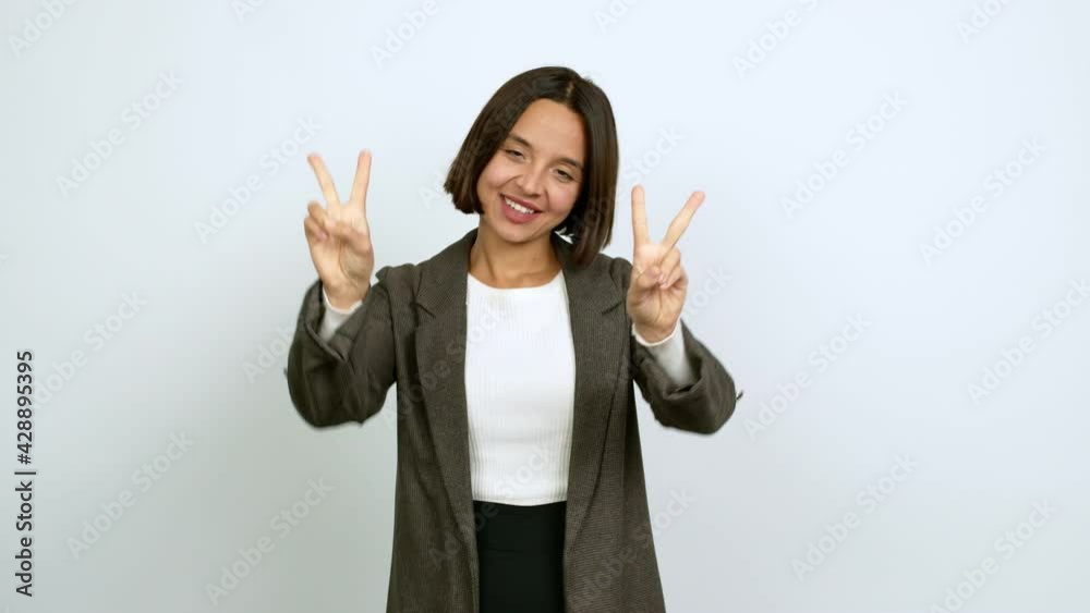 Young latin woman smiling and showing victory sign with a cheerful face over isolated background Young latin woman smiling and showing victory sign with a cheerful face over isolated background