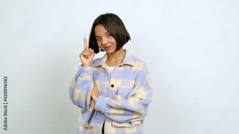 Young latin woman intending to realizes the solution while lifting a finger up over isolated background Young latin woman intending to realizes the solution while lifting a finger up over isolated background