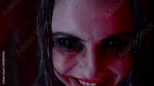 demoniac woman with large dark eyes and blood from mouth, looking at camera, possession by devil