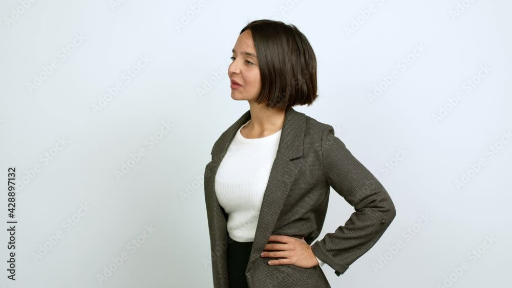 Young latin woman shouting to the lateral and announcing something over isolated background Young latin woman shouting to the lateral and announcing something over isolated background