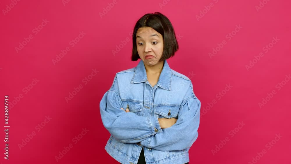Young latin woman making unimportant and doubts gesture while lifting the shoulders and the palms of the hands over isolated background Young latin woman making unimportant and doubts gesture while lifting the shoulders and the palms of the hands over isolated background