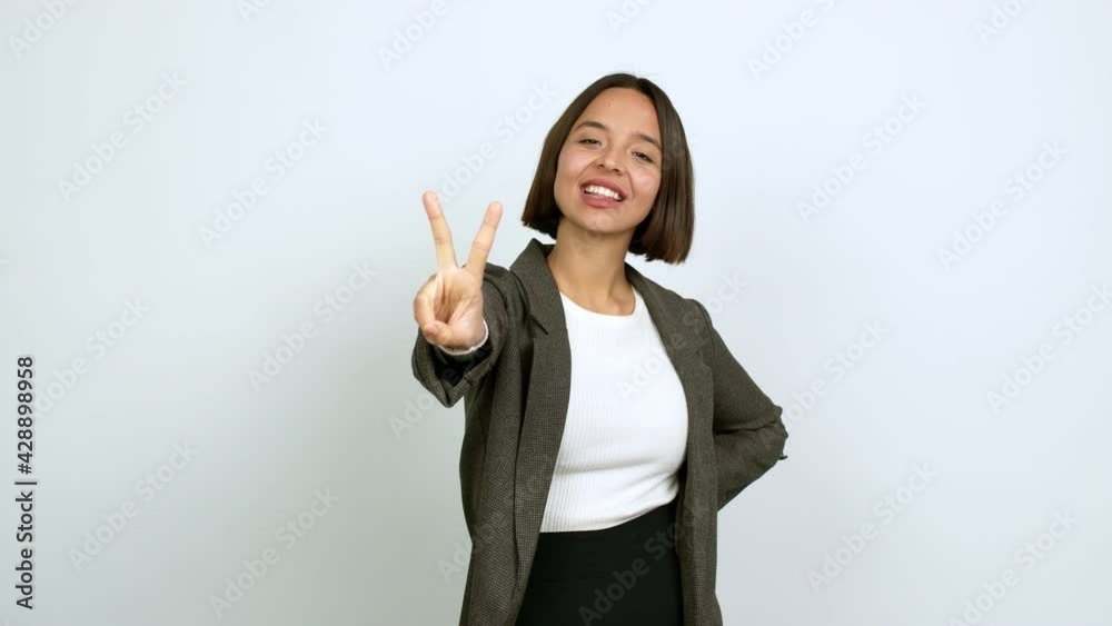 Young latin woman happy and counting with fingers over isolated background Young latin woman happy and counting with fingers over isolated background