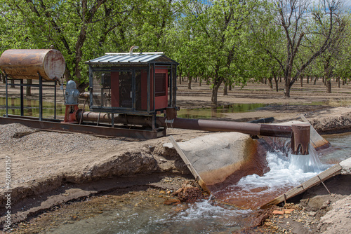 A pump delivering water to an acequia or irrigation ditch  in the pecan groves of southern New Mexico. Because of drought, river water is not available for irrigation. 
 photo