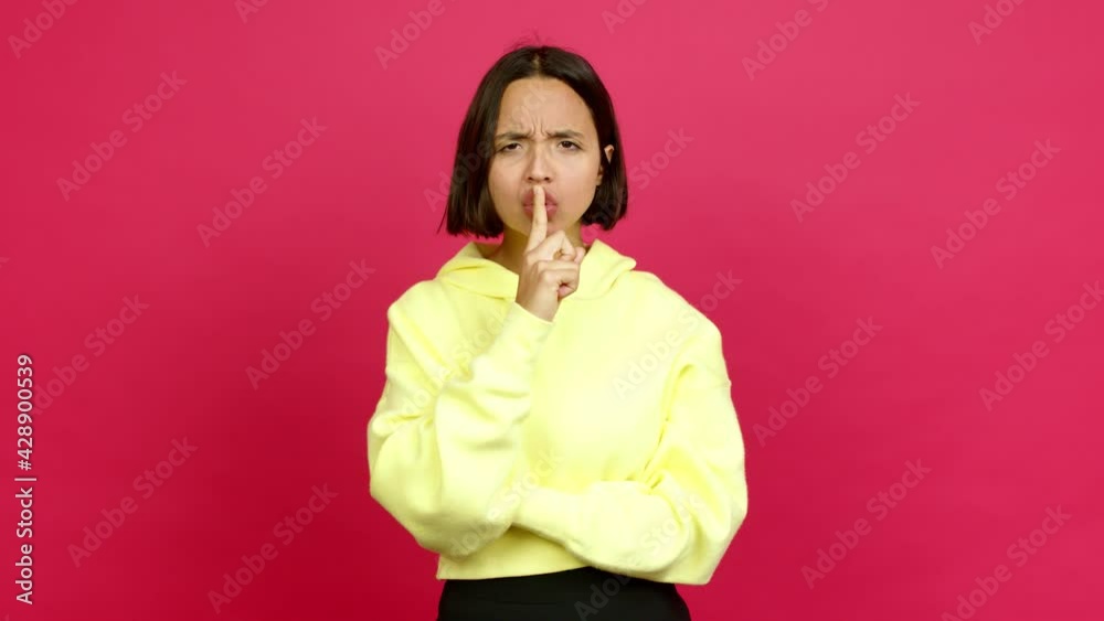Young latin woman doing silence gesture over isolated background