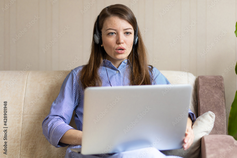 Shocked frightened afraid worried young woman in headphones looking at laptop computer terrified read bullying social media film tv message surprise stress panic Shocked frightened afraid worried young woman in headphones looking at laptop computer terrified read bullying social media film tv message surprise stress panic