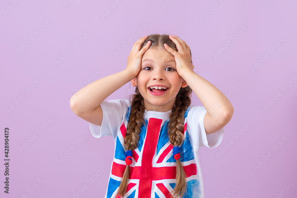 A girl with an image of the English flag on a T-shirt is very happy to learn English. A girl with an image of the English flag on a T-shirt is very happy to learn English.