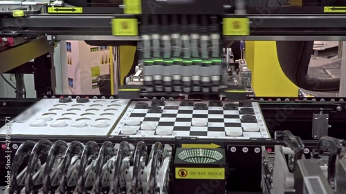 Equipment for the electronics industry: demonstration of the machine's ability to install components, using the example of a game of checkers photo