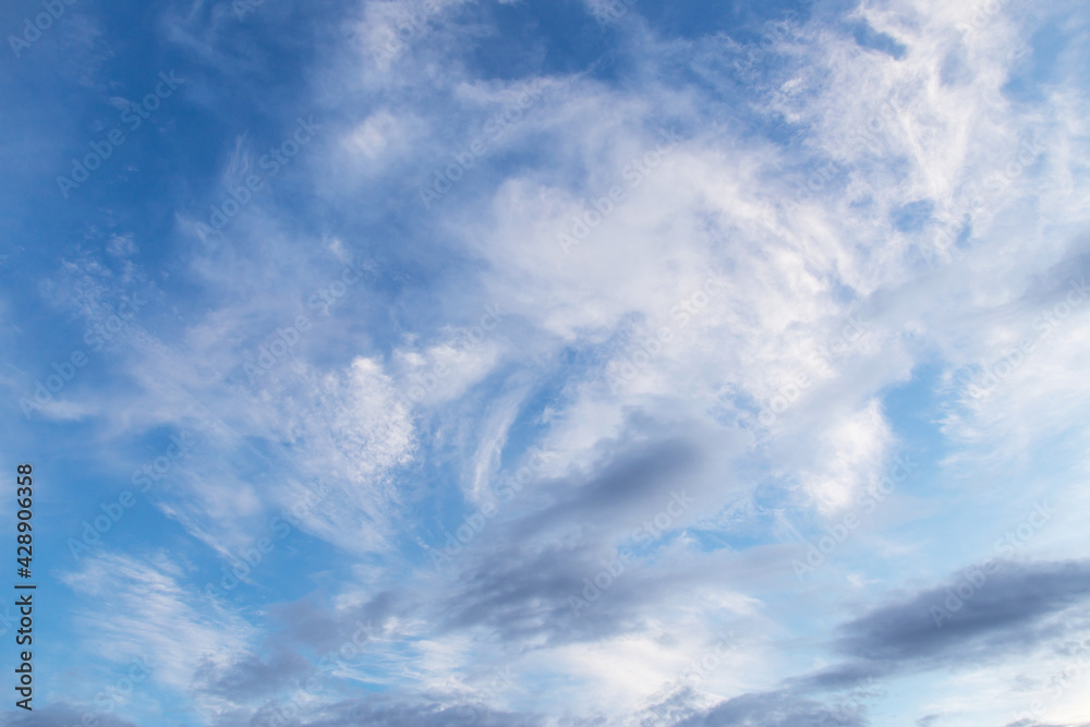 Beautiful epic blue sky with white and grey cirrus clouds background texture	