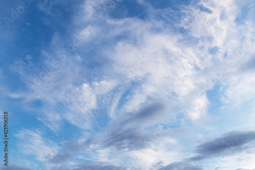 Beautiful epic blue sky with white and grey cirrus clouds background texture 