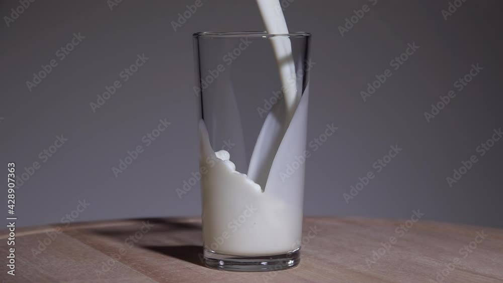 Milk is poured into a glass. Slow motion 250fps Milk is poured into a glass. Slow motion 250fps