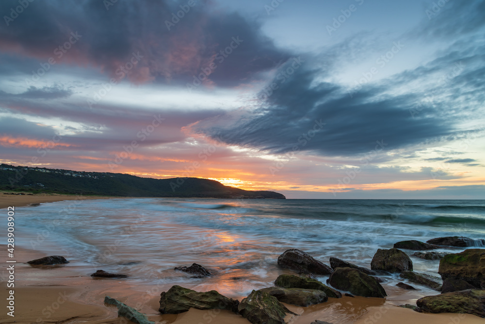 Sunrise at the seaside with pastel coloured clouds Sunrise at the seaside with pastel coloured clouds